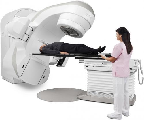 image of a nurse working with a man receiving radiation therapy